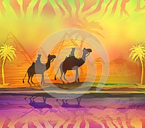 Camel train silhouetted against colorful sky crossing the Sahara