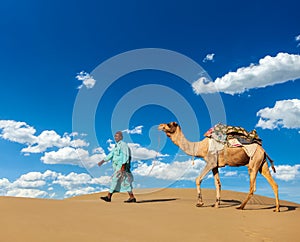 Cameleer (camel driver) with camels in Rajasthan, India