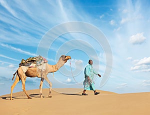 Cameleer camel driver with camels in Rajasthan, India