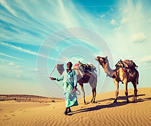 Cameleer with camels in dunes of Thar desert. Raj