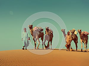 Cameleers with camels in desert - vintage retro style