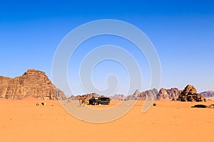 Camels at a bedouin tent in the middle of the Wadi Rum desert in