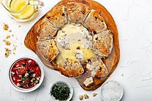 Camembert baked in the oven with herb bread served