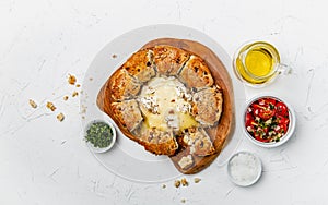 Camembert baked in the oven with herb bread served