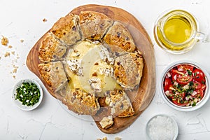 Camembert baked in the oven with herb bread served