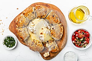 Camembert baked in the oven with herb bread served