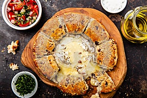 Camembert baked in the oven with herb bread served with tomato salad