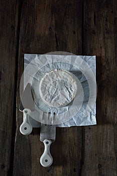 Camembert cheese with cheese fork and cheese knife