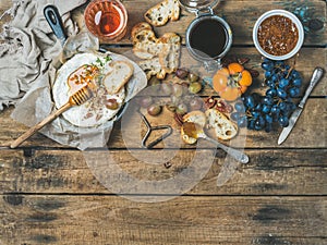 Camembert cheese, fruits, bread, honey, nuts, jam and rose wine