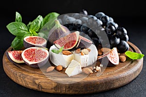 Camembert cheese platter with figs, grapes and nuts