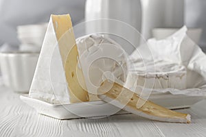 Camembert cheese on a white wooden table