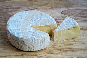 Camembert cheese on wooden table