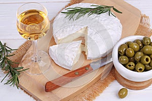 Camembert cheese with olives and white wine