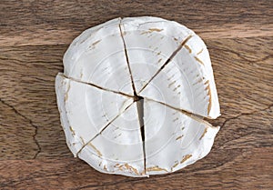 Camembert on a wooden board. Camembert cheese on a board close-up