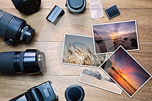 Camera accessories with photos on vintage wooden background