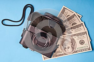 Camera and a bunch of hundred-dollar American bills