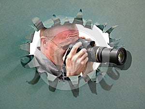 Camera cameraman using lens through hole in card breakthrough tear disguise