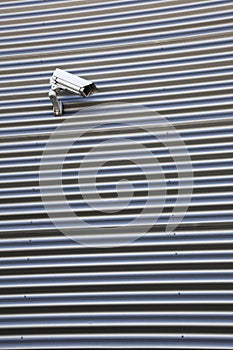 Camera on corrugated iron building