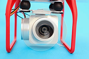 Camera of a drone, a quadrocopter close-up on a blue background