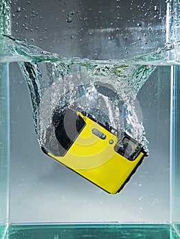 camera dropped in container water with splash