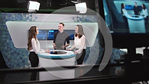 Camera filming tv show with host and two women