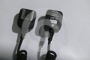 Camera flash sync cable on blue background