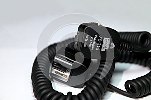 Camera flash sync cable on blue background