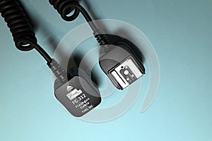 Camera flash sync cable on blue background