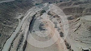 Camera flies over the dried out bed of Naquibs Pond in Wadi Hanifa near Riyadh