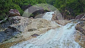 Camera Flies over River with Waterfall Cascade Running Fast