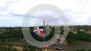 The camera flies past a waving flag of the Dominican Republic