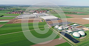 Camera flight over biogas plant from pig farm. Renewable energy from biomass. Modern agriculture European Union. aerial