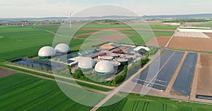 Camera flight over biogas plant from pig farm. Renewable energy from biomass. Modern agriculture European Union. aerial