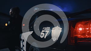 Camera Focus on Police Car Logo and Number. Female Officer Leaving the Car to Inspect a Road