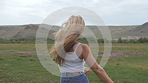 Camera follow hipster young woman in white t-shirt short jeans fluttering long hair. One girl dancing to the portable