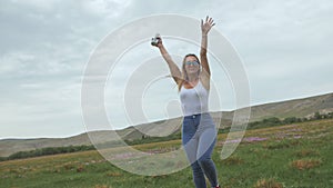 Camera follow hipster young woman in white t-shirt short jeans fluttering long hair. One girl dancing to the portable