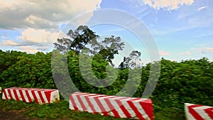 Camera Follows Scooter along Sunny Road among Country Landscape