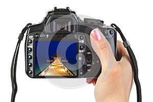 Camera in hand and beach landscape