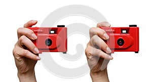Camera in a hand isolated on white background