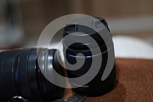 A camera len placed on bed.