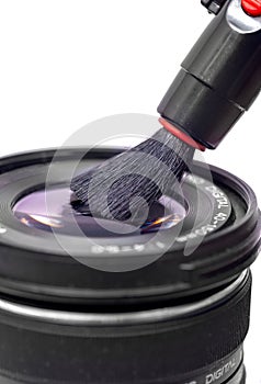 camera lens cleaning through lenspen on white background