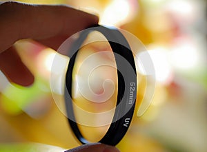 Camera lens filter being held