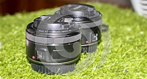 Camera lens on grassy background