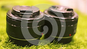 Camera lens on grassy background