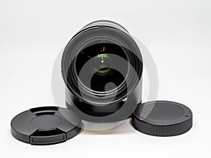 Camera lens with a hood and caps on a white background.