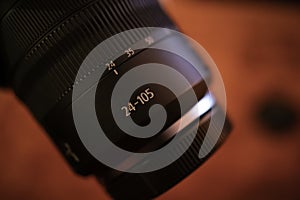 Camera lens 24-105 mm on dark red background