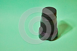 camera lens with protective cover on a green background photo