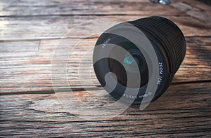 Camera lens on a rustic wooden table