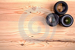 Camera lenses on wooden table top view. background and workspace for photography