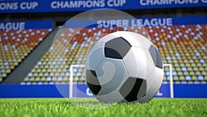 Camera move towards a soccer ball lying on grass in an empty stadium